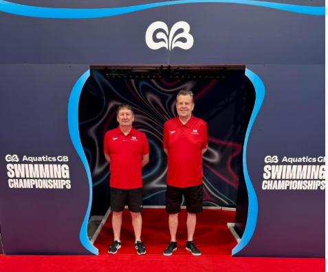 Darren Maxwell and Graham Robinson volunteering as marshals at the 2026 Aquatics GB Swimming Championships